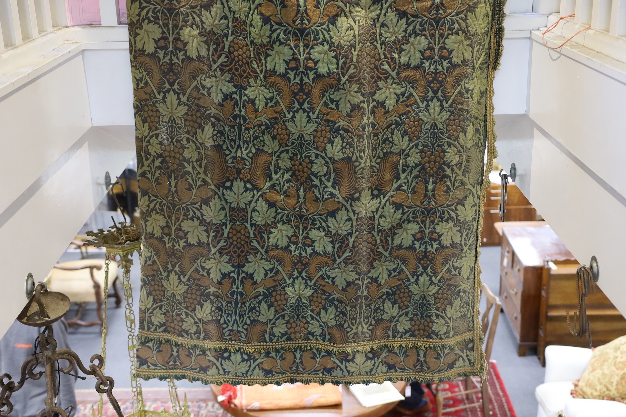 John Henry Dearle for Morris & Co. a pair of Squirrel design curtains, c.1890, hand loom woven wool at Merton Abbey, each with ornate braided edging and lining: 8ft 6ins. drop x 4ft wide each